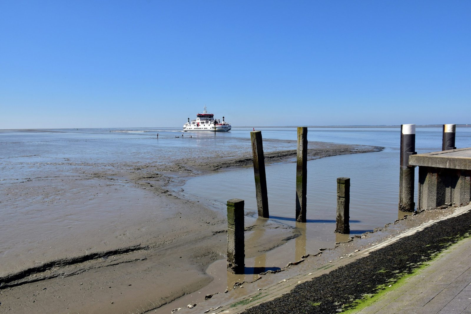 a boat is out on the water near a pier